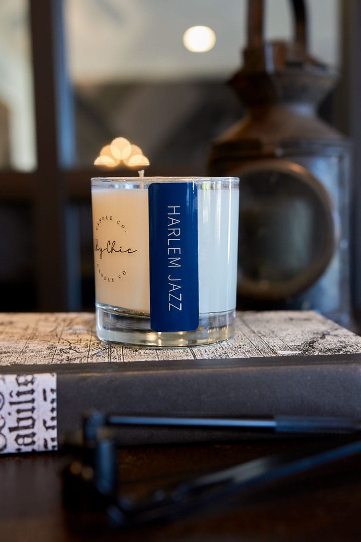 Candle labeled 'Harlem Jazz' on a textured surface with a blurred background