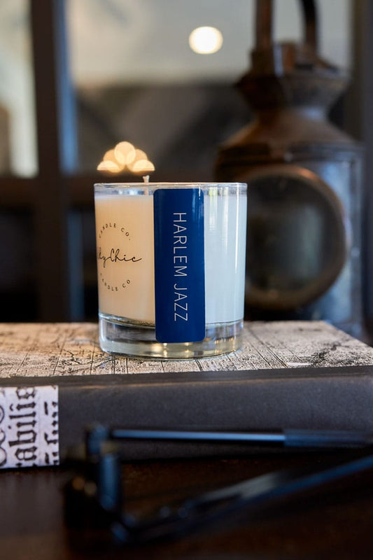 Candle labeled 'Harlem Jazz' on a textured surface with a blurred background