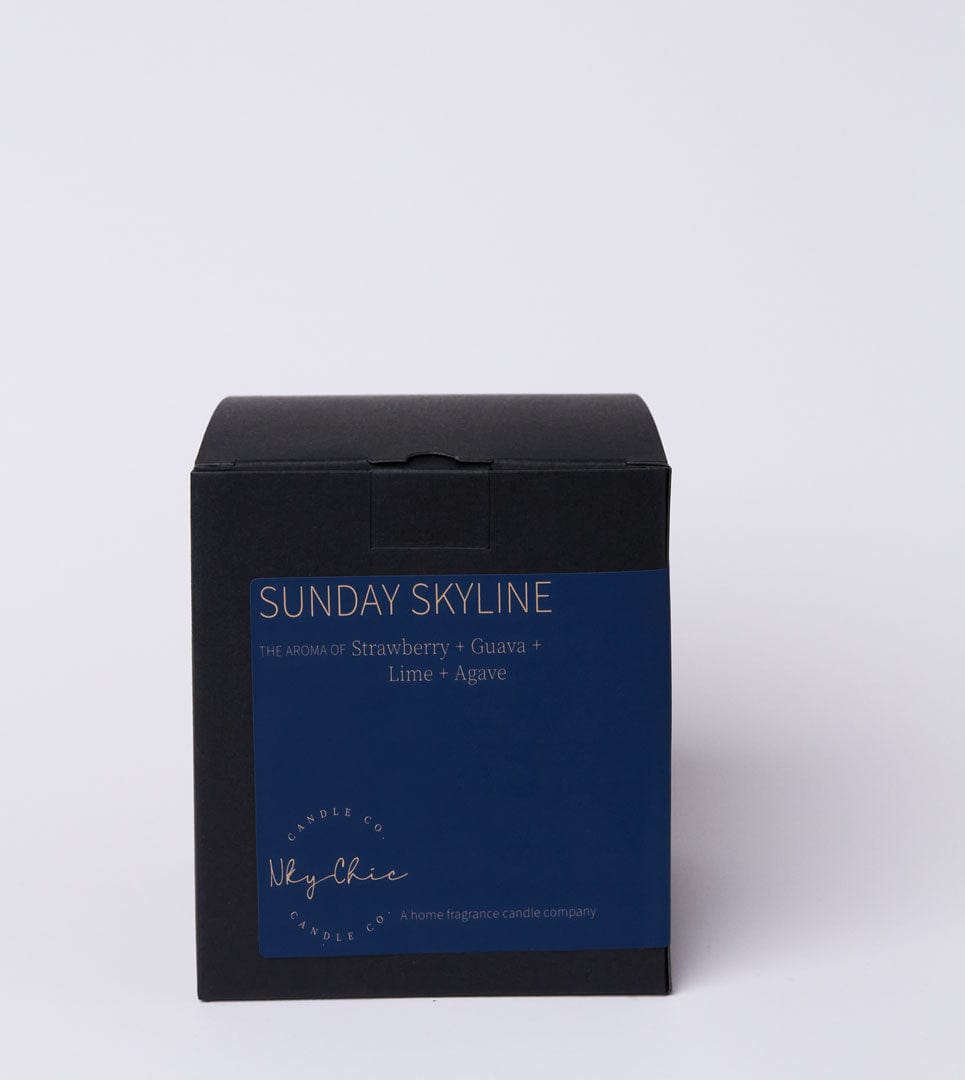 Black and blue candle box with 'Sunday Skyline' branding on a light gray background